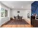 Dining room with large window, hardwood floors, and seating for four at 2658 W 1St Ave, Denver, CO 80219