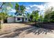 Exterior view of home with a private driveway and fenced-in yard, showcasing curb appeal at 2658 W 1St Ave, Denver, CO 80219