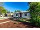 Single-story home featuring a front yard with mature trees and a mulch lawn at 2658 W 1St Ave, Denver, CO 80219