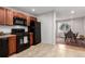 Kitchen with dark appliances, wood cabinets, tile floors, and an adjacent dining area at 2658 W 1St Ave, Denver, CO 80219