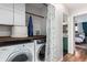 Functional laundry area with modern washer and dryer, complemented by storage options and stylish decor at 2658 W 1St Ave, Denver, CO 80219