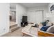 Bright living room featuring neutral tones, television, and cozy furniture, creating an inviting space for relaxation at 2658 W 1St Ave, Denver, CO 80219