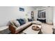 Comfortable living room with large sofa, throw pillows, and natural light at 2658 W 1St Ave, Denver, CO 80219