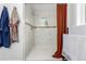 Bright shower with white marble surround, shower head, and mosaic tile accent at 2658 W 1St Ave, Denver, CO 80219