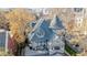 Aerial view of charming house with turret, balcony, detailed roof, and mature trees at 1459 N Pennsylvania St # B, Denver, CO 80203