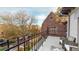 Back porch with black iron fence, decorative trees, and seating at 1459 N Pennsylvania St # B, Denver, CO 80203