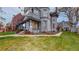 Gray house showcasing a turret with detailed shingle siding and lush green lawn at 1459 N Pennsylvania St # B, Denver, CO 80203