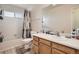 Bright bathroom features a shower-tub combo, vanity with sink, and neutral finishes at 9882 Harris St, Thornton, CO 80229
