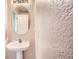 Bright bathroom featuring a white sink, a mirror, and a shower-tub combo at 9882 Harris St, Thornton, CO 80229