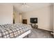 Main bedroom features a carpet, a ceiling fan, a bed, and access to an adjoining room at 9882 Harris St, Thornton, CO 80229