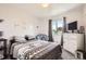 Comfortable bedroom with a full-sized bed, a window, and a chest of drawers at 9882 Harris St, Thornton, CO 80229