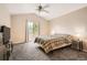 Vaulted main bedroom with a ceiling fan, a window, and a comfortable bedspread at 9882 Harris St, Thornton, CO 80229
