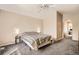 Bright main bedroom with vaulted ceiling, carpet, and a large bed at 9882 Harris St, Thornton, CO 80229