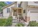 Inviting front porch with decorative flower pots and brick accents for added curb appeal at 9882 Harris St, Thornton, CO 80229
