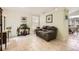 Cozy living area featuring neutral tile flooring, a sofa, and view into the kitchen at 9882 Harris St, Thornton, CO 80229