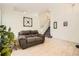 Inviting living room showcasing neutral tile flooring, a comfortable sofa, and staircase at 9882 Harris St, Thornton, CO 80229