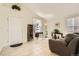 Bright living room with neutral tile flooring, large windows, and a comfortable sofa at 9882 Harris St, Thornton, CO 80229