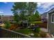 Large backyard featuring a play area, garden, and mature trees, creating a perfect space for outdoor activities at 12498 W Prentice Dr, Littleton, CO 80127