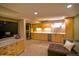 Finished basement boasts a bar, in-unit laundry, and comfortable seating at 12498 W Prentice Dr, Littleton, CO 80127