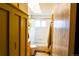 Well-lit bathroom with a skylight, features tile flooring and a combination shower/tub at 12498 W Prentice Dr, Littleton, CO 80127