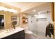 Bright bathroom featuring a glass-enclosed shower with a patterned tile accent and a modern vanity with drawers at 12498 W Prentice Dr, Littleton, CO 80127