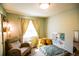 Inviting bedroom featuring a comfy chair, bright window, and playful decor at 12498 W Prentice Dr, Littleton, CO 80127