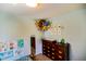 Bedroom corner features a dresser-changing table and stuffed animal storage at 12498 W Prentice Dr, Littleton, CO 80127