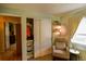 Comfortable bedroom with closet space, cozy chair, and natural light from a window at 12498 W Prentice Dr, Littleton, CO 80127