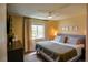 Bright primary bedroom featuring a queen bed, large window, and comfortable decor at 12498 W Prentice Dr, Littleton, CO 80127