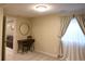 Office space complete with a writing desk and large window with curtains at 12498 W Prentice Dr, Littleton, CO 80127