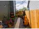 Cozy side yard featuring a wooden pathway, potted plants, and string lights, creating a charming outdoor retreat at 12498 W Prentice Dr, Littleton, CO 80127