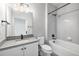 Bathroom featuring a shower and tub combination with sleek vanity and modern lighting at 2078 S Holly St # 1, Denver, CO 80222