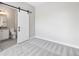 Bedroom with a sliding door to the bathroom and neutral carpet at 2078 S Holly St # 1, Denver, CO 80222