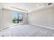 A light-filled bedroom with large windows and neutral carpet offers a serene retreat at 2078 S Holly St # 1, Denver, CO 80222