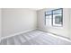 Bright bedroom with a large window providing ample natural light and neighborhood views at 2078 S Holly St # 1, Denver, CO 80222
