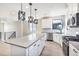 Modern kitchen with a large island, stainless appliances, and gray countertops at 2078 S Holly St # 1, Denver, CO 80222