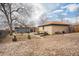 Large, open backyard with mature trees, hammock, and detached garage and patio area perfect for outdoor living at 7930 Quitman St, Westminster, CO 80030