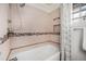 Clean bathroom with a tub featuring a shower and a tiled wall design at 7930 Quitman St, Westminster, CO 80030
