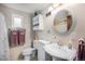 Clean bathroom with a white porcelain sink, a round mirror and an exhaust fan at 7930 Quitman St, Westminster, CO 80030
