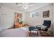 Well-lit bedroom featuring an accent chair, and a display of art on the wall at 7930 Quitman St, Westminster, CO 80030