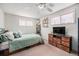 Bright bedroom features a ceiling fan, neutral carpet, light walls, and furniture at 7930 Quitman St, Westminster, CO 80030