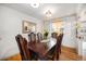 Elegant dining room with a large wooden table, seating for eight, and a view into the kitchen at 7930 Quitman St, Westminster, CO 80030
