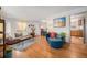 Bright living room with hardwood floors, stylish furniture, and an open layout connecting to the dining area at 7930 Quitman St, Westminster, CO 80030