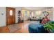 Inviting living room featuring hardwood floors, a decorative front door, and bright, sunny windows at 7930 Quitman St, Westminster, CO 80030
