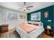 Cozy main bedroom with hardwood floors, ceiling fan, two large windows, and an accent wall at 7930 Quitman St, Westminster, CO 80030