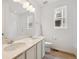 Bright bathroom featuring a double sink vanity, a window, and a combined tub and shower at 6615 N Nepal St, Aurora, CO 80019