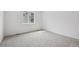 A bright, neutral bedroom with carpeted floor and a large window for great natural light at 6615 N Nepal St, Aurora, CO 80019