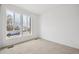 A bright bedroom featuring large windows, neutral walls and plush carpeting at 6615 N Nepal St, Aurora, CO 80019