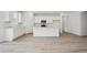 Kitchen features sleek white cabinetry, stainless steel appliances, and a functional island at 6615 N Nepal St, Aurora, CO 80019