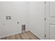 Laundry room with hook ups, a window, and wood-look flooring at 6615 N Nepal St, Aurora, CO 80019